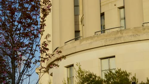 The Federal Trade Commission building's name is etched in stone in the light of dawn