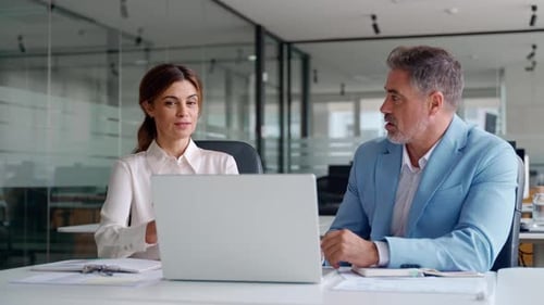 Two Happy Professional Business Executives Working in Office Looking at Laptop