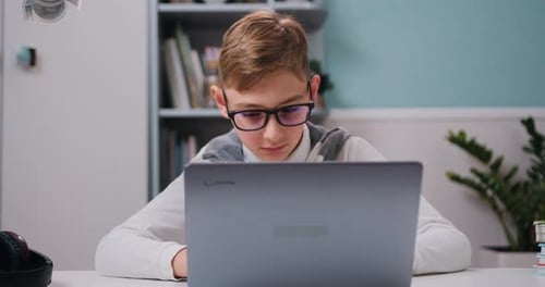 Focused Boy Using Laptop for Online Education