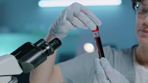 Scientist Examining Blood Sample in Lab