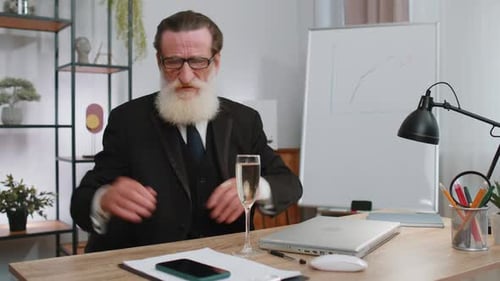 Senior Man Celebrates Success with Champagne in Office