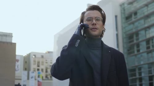 Serious Businessman Talking on Smartphone at City Street. Focused Business Man Using