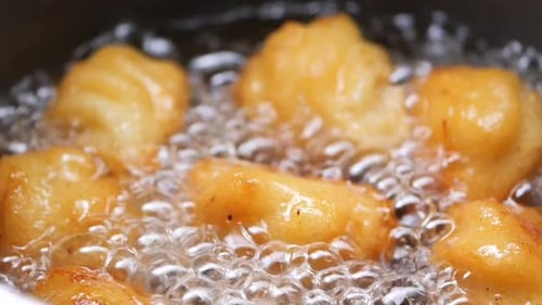 Golden Brown Dough Balls Frying in Hot Oil