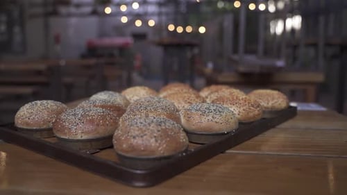 Close up orbit shot of fresh backed rolls or buns in bakery shop