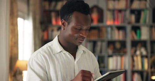 Black man, tablet and scroll in home for social media, connectivity or browse website