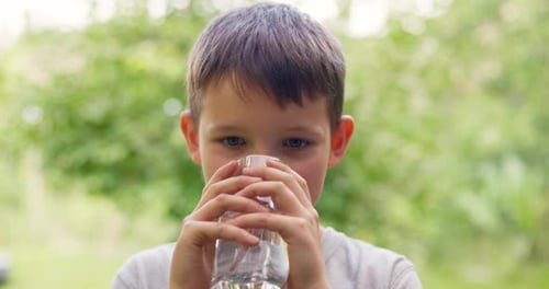 Boy Drinking Refreshing Water in Natural Setting