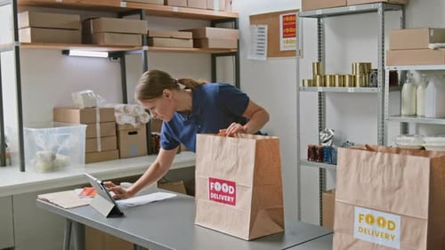 Two Diverse Workers Packing Groceries and Fresh Produce Orders in Dark Store