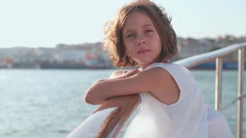 Junges Mädchen genießt einen sonnigen Tag am Wasser in der Küstenstadt
