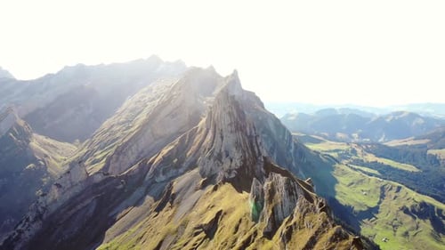 Aerial flyover over Schaefler ridge in Appenzell, Switzerland with the lush slopes in vibrant green