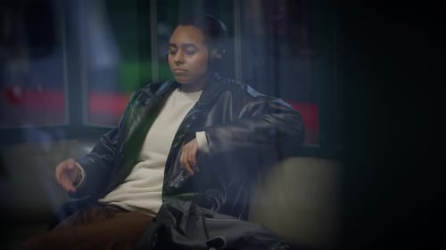 Woman Relaxing with Headphones on City Train at Night
