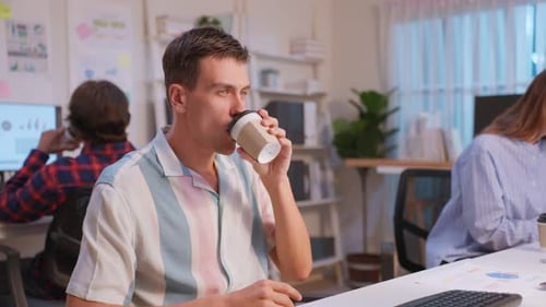 Group of business person eating doughnut while working in the office.