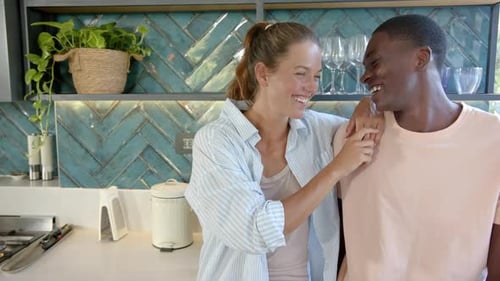 Happy Couple Embracing in Modern Kitchen