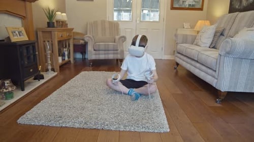 Boy Plays with VR Headset in Cozy Living Room