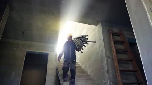 Construction worker accidentally falls from ladder at the job site in slow motion