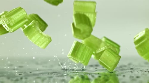 Sliced Pieces of Fresh Celery Fall on the Table Filmed on a Highspeed Camera at 1000 Fps