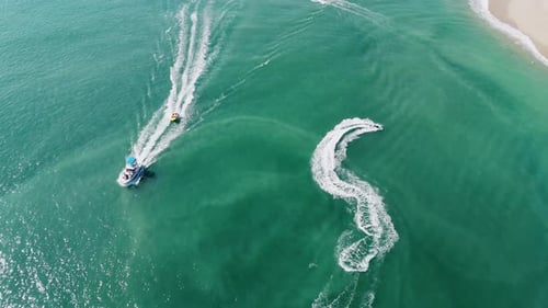 Yachts And Jet Ski Riding On The Sea