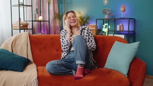 Woman Chatting on Phone While Sitting on Couch