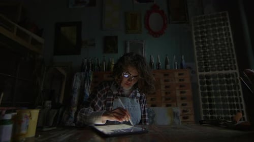 Woman Working On Tablet Computer In The Dark