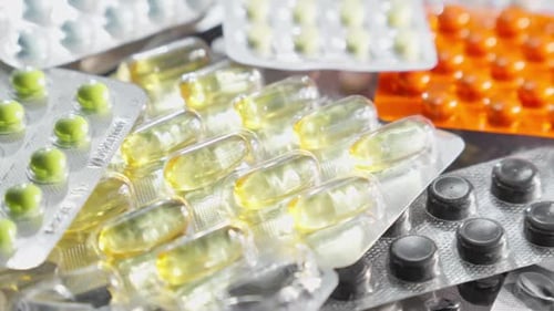 Blisters with Medicines on Table Rotating Variety of Pharmaceutical Pills