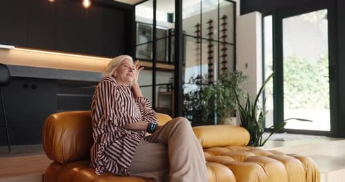 Senior Woman Relaxing on a Modern Sofa