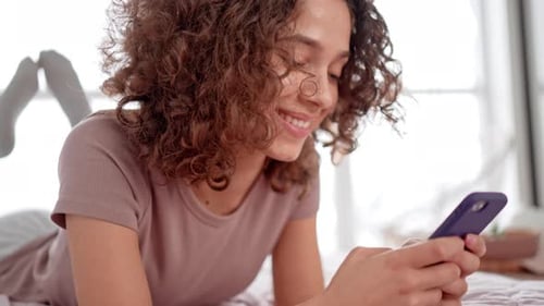Female Messaging on Mobile in Apartment