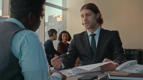Diverse Business Partners Having Negotiations in Office