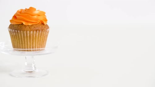 Delicious Cupcake with Orange Frosting on Display