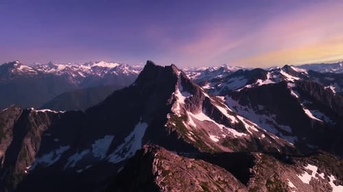Dramatic Rocky Peak and Mountain Landscape Snow Colorful Sunset Sky Late Winter Early Spring