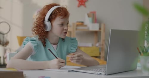 Girl Attends Online Class with Laptop and Headphones