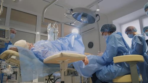 A Team of Professional Doctors and Nurses Performs Surgery in the Operating Room