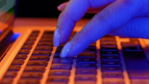 Close Up of Hands Typing on a Laptop Keyboard