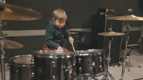 Young Talented Boy Playing Drums in Music Studio