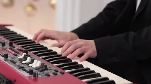 Hands of male musician playing at synthesizer. Mens arms plays solo of music or new melody. Close up