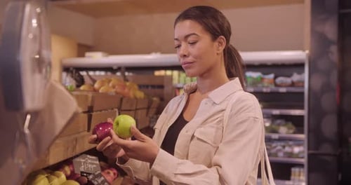Black Female Customer Choosing Fresh Fruit Groceries in Supermarket Store
