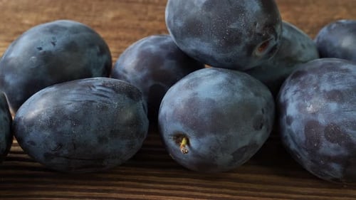 Plums on Wooden Surface Dolly Shot