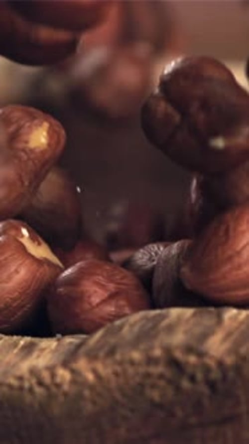 Hazelnuts Fall Into a Wooden Bowl Filmed on a Highspeed Camera at 1000 Fps