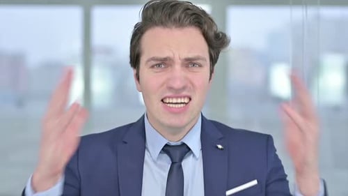 Frustrated Man in Suit Raises Arms and Shouts