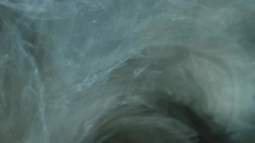 Abstract Shot of White Paint Swirling in Water