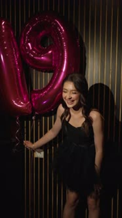 Excited Woman Celebrates 19th Birthday with Balloons