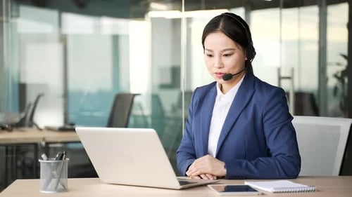 Woman Video Conferencing in Office Setting