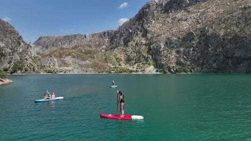 Aerial View Paddleboarders Enjoying a Peaceful Trip Through the Green Canyon Swimming and Sunbathing