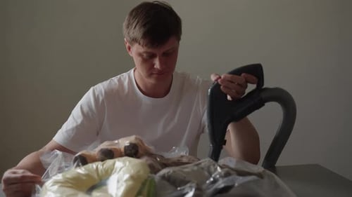 Man Using Vacuum to Seal Storage Bag