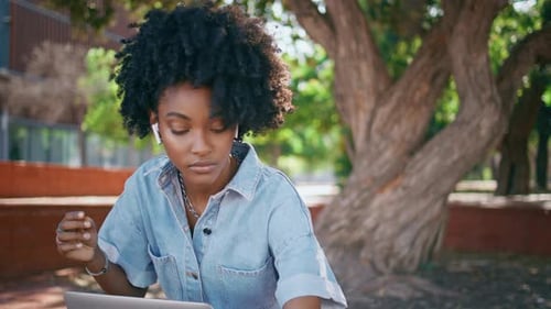 Teenager Headphones Turning Music at Smartphone Sitting Park with Laptop Closeup