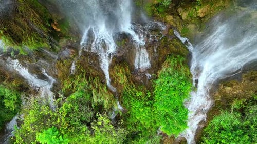 Beautiful waterfall in a tropical forest by aerial view from a drone.