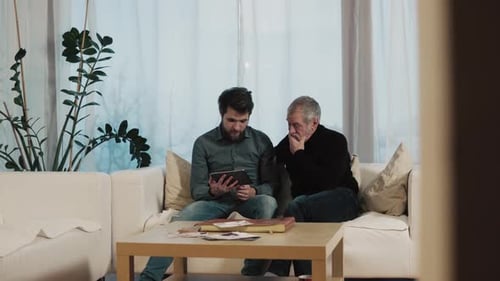 Hipster Son and His Senior Father with Tablet at Home