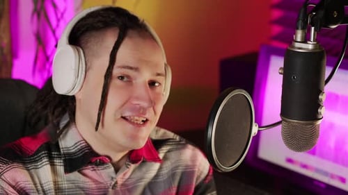 Man Speaking into Microphone in Recording Studio