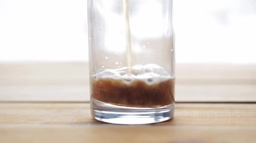 Unhealthy Eating and Drinks Concept - Lemonade or Soda Drink Pouring Into