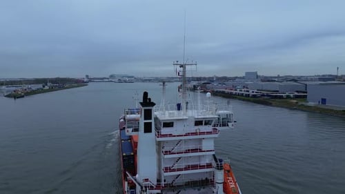 Inland Vessel With Cargo Traveling Across The River In Dordrecht, Netherlands. - aerial