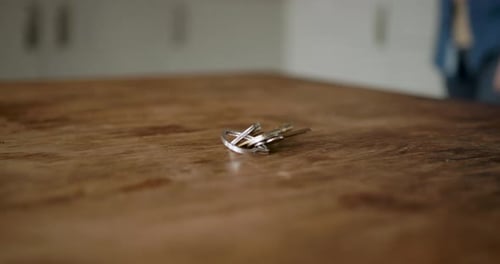 Close-up of Person picking up Keys on Table, leaving for Work