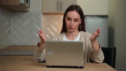 Woman Communicates in a Video Call on Laptop